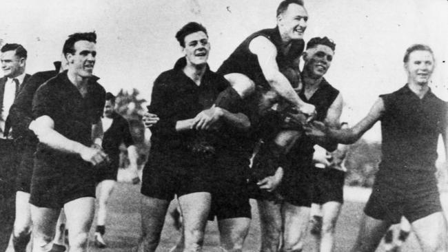 Norwood players carry their captain-coach Jack Oatey from the field after winning the 1946 premiership.