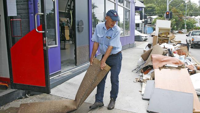 Robert Archibald is seen cleaning up after his business in Milton flooded.