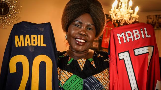 Awer Mabil's mum Agot Dau Atem shows her delight after he scored a goal for the Socceroos on debut. Picture: AAP/Mike Burton