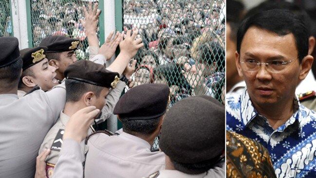 Police secure the gate of Jakarta's Cipinan prison in the face of protests from supporters of Basuki Tjahaja ‘Ahok’ Purnama (right).