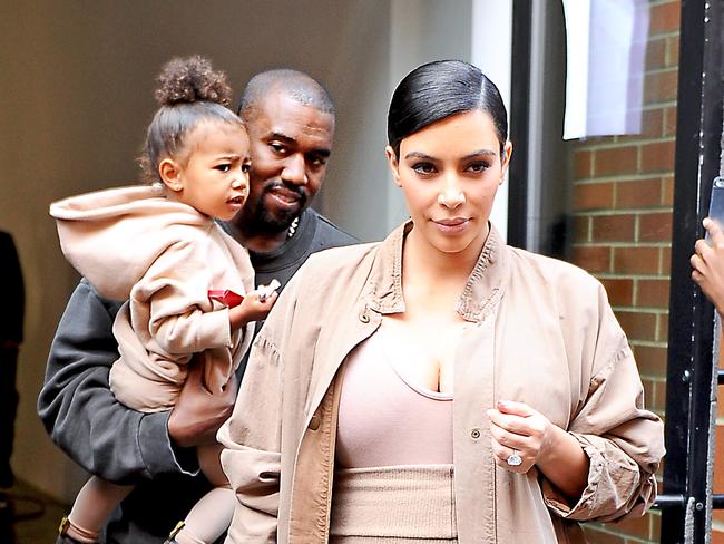 Kim Kardashian and Kanye West carrying North West in NYC.