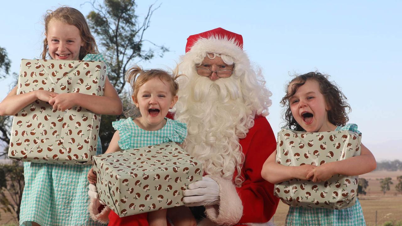 Santa visits the Walker family children Elsie 7yrs, Lucy 3yrs and Callie 5yrs at their farm in Booleroo Centre. Picture: Emma Brasier