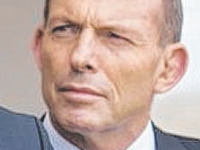 Prime Minister Tony Abbott looks on as Andrew Hastie (Liberal candidate for Canning) addresses the media at the Port Bouvard Surf Life Saving Club.