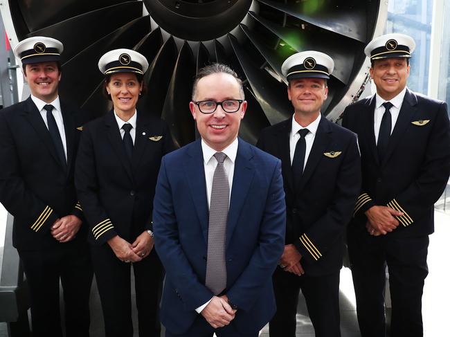 25/8/17: Qantas CEO Alan Joyce poses with some Qantas crew after reporting Qantas full year financial result at Qantas HQ in Sydney. John Feder/The Australian.