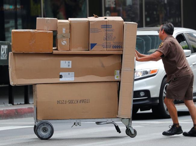 Merchants who use UPS and FedEx may break up shipments or visit delivery sites more often to manage the fees. PHOTO: MIKE BLAKE/REUTERS