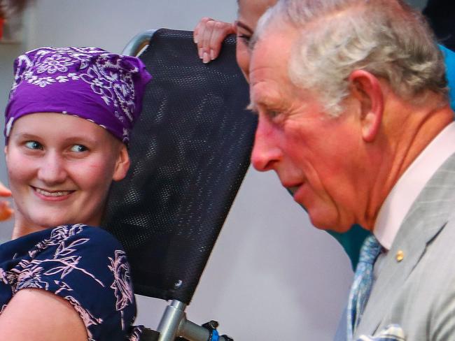 Britain's Prince Charles sits with Abbi Head, 13 (left) of Brisbane during his official visit to the Lady Cilento Children's Hospital in Brisbane, Wednesday, April 4, 2018. The 2018 Gold Coast Commonwealth Games will be officially opened by HRH Charles at Carrara Stadium later this evening. (AAP Image/AFP Pool/Patrick Hamilton)