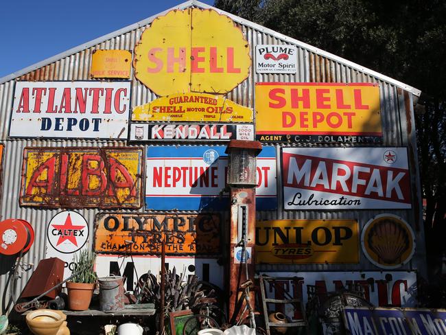 Retro steel advertising signs including Shell, Caltex, Atlantic Depot, Olympic Tyres and Marfak Lubrication are all on display.