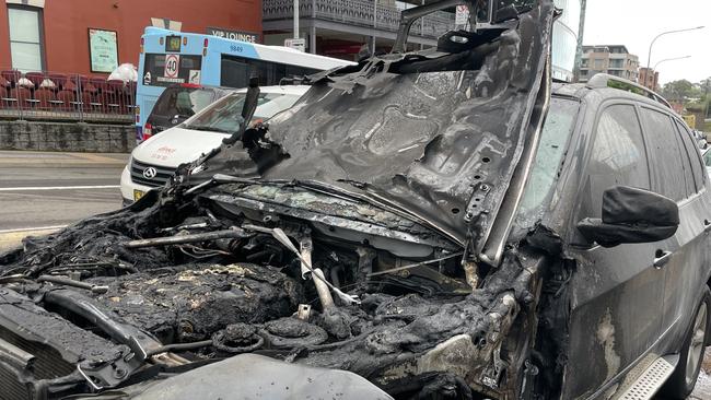 A BMW X5 at Parramatta after the bonnet went up in flames.