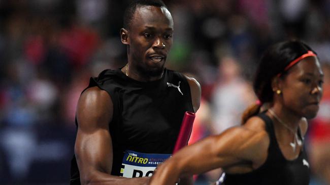 Usain Bolt passes the baton to Jenna Prandini in the Mixed 4x100m relay, his only event on the second evening of Nitro Athletics.