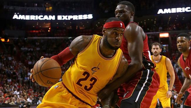 James drives on Luol Deng #9 of the Miami Heat.