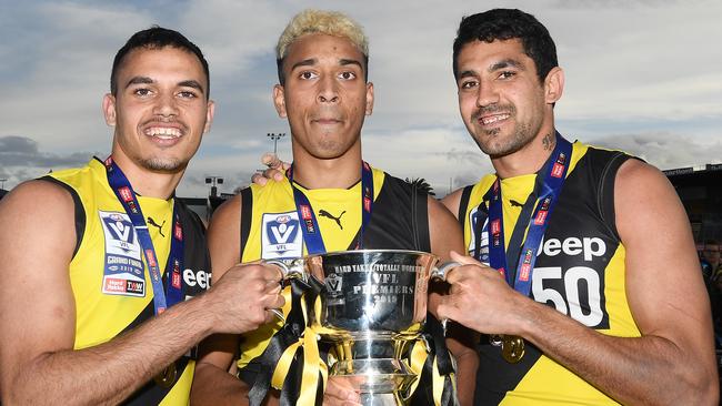 Sydney Stack, Derek Eggmolesse-Smith and Marlion Pickett celebrate their VFL premiership victory last weekend. Picture: Getty Images