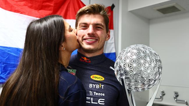 SUZUKA, JAPAN - OCTOBER 09: Race winner and 2022 F1 World Drivers Champion Max Verstappen of Netherlands and Oracle Red Bull Racing celebrates with Kelly Piquet and his trophy after the F1 Grand Prix of Japan at Suzuka International Racing Course on October 09, 2022 in Suzuka, Japan. (Photo by Mark Thompson/Getty Images )