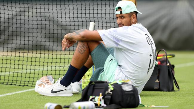 Nick Kyrgios takes a break on the practice court at Wimbledon overnight (AEST). Picture: Getty Images