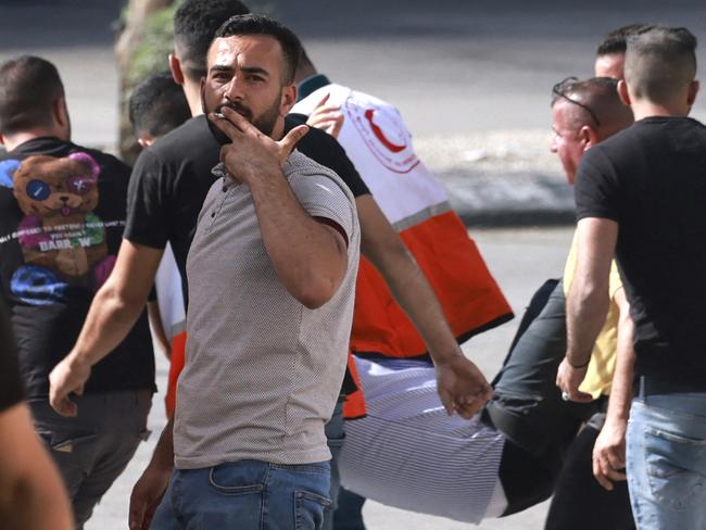 First responders evacuate a Palestinian man injured during clashes with Israeli soldiers after Jewish settlers stormed the Palestinian West Bank village of Dayr Sharaf, located about 7km from the Jewish Einav settlement. Picture: AFP