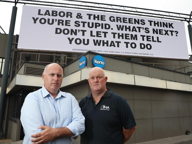 Love Your Local chairman Michael Best with Tasmanian Hospitality Association chief Steve Old outside an election billboard during the 2018 state election campaign. Picture: LUKE BOWDEN