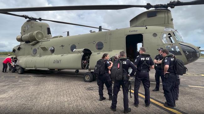 Police and other emergency personnel board Chinook helicopters to fly to the township of Wujal Wujal. Picture Queensland Police