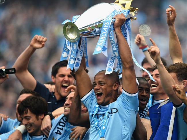 MANCHESTER, ENGLAND - MAY 11: Vincent Kompany of Manchester City lifts the Premier League trophy at the end of the Barclays Premier League match between Manchester City and West Ham United at the Etihad Stadium on May 11, 2014 in Manchester, England. (Photo by Shaun Botterill/Getty Images)