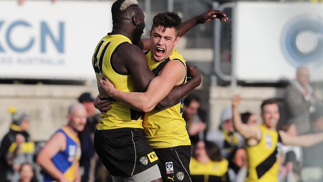 Patrick Naish (right) celebrates Richmond’s VFL grand final win with Mabior Chol. Picture: Michael Klein.