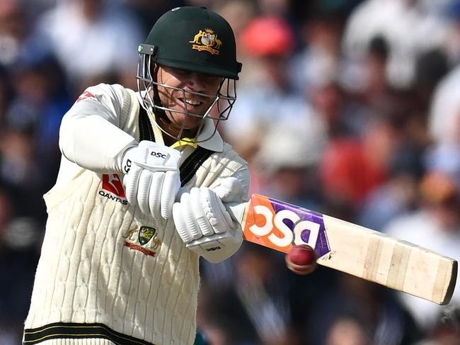 Australia's David Warner plays a shot on day three of the fourth Ashes cricket Test match between England and Australia at Old Trafford cricket ground in Manchester, north-west England on July 21, 2023. (Photo by Oli SCARFF / AFP) / RESTRICTED TO EDITORIAL USE. NO ASSOCIATION WITH DIRECT COMPETITOR OF SPONSOR, PARTNER, OR SUPPLIER OF THE ECB