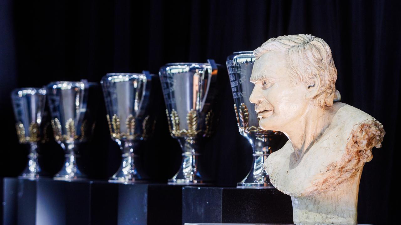 A bust on stage with premiership trophies during the memorial. Picture NCA NewsWire / Aaron Francis