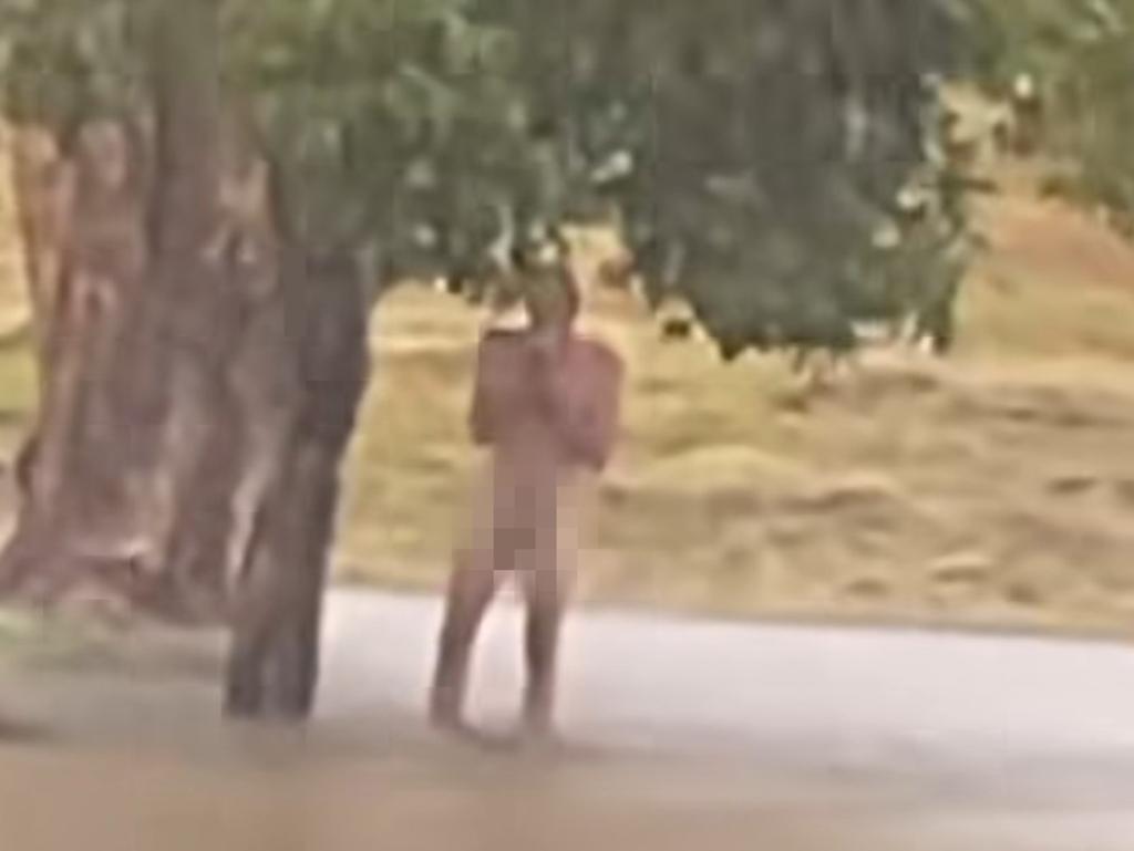 A man swimming naked in floodwaters in Lismore. Pic: Facebook