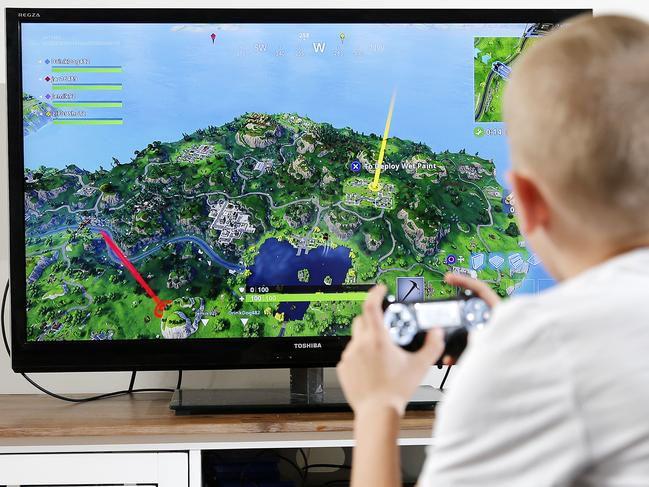 Cooper Thompson posing at his Capalaba home, Brisbane 11th of August 2018.  Cooper is playing the game Fortnite on a PS4.  (AAP Image/Josh Woning)