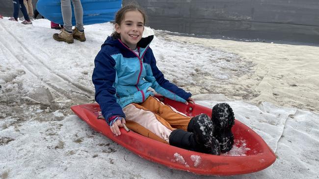 Ten-year-old Rubie Morrissey sliding down the hill on a toboggan on day 2 of the 2021 Snowflakes in Stanthorpe festival. Photo: Madison Mifsud-Ure / Stanthorpe Border Post