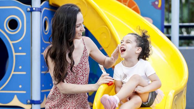 Rebecca Lolohea from Worongary applies sunscreen to daughter Tiare, 3. Pic Tim Marsden