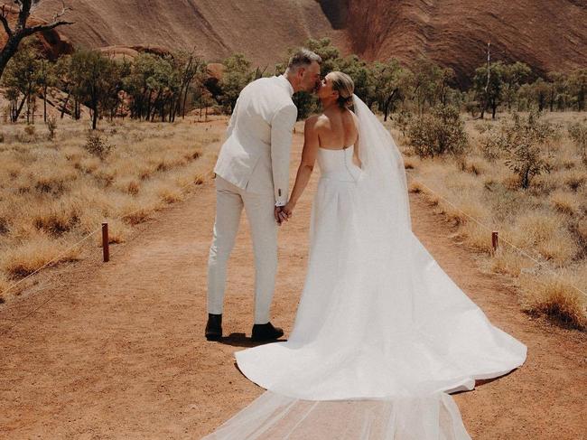 Abbey Holmes with husband Keegan Brooksby at their picturesque wedding in the Northern Territory last year. Picture: @abbeycholmes @lillyatdawn via Instagram