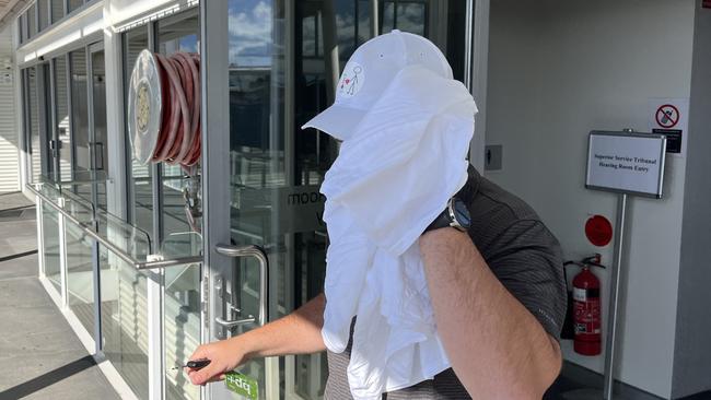 Chief Petty Officer Ashley Hoogwerf shields his face as he leaves the Defence Force Magistrates Court in Canberra. Picture: Julia Kanapathippillai