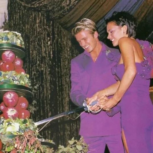 The couple cut their wedding cake.