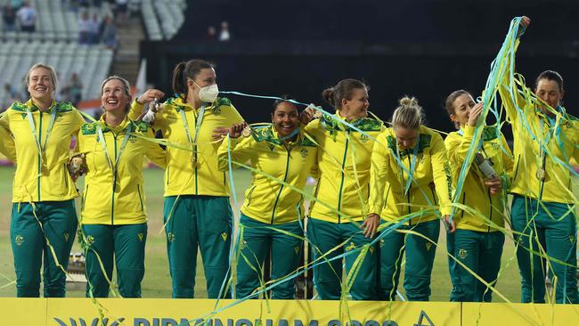 Australia team celebrates as Tahlia McGrath wears a mask Picture: Darren Staples / AFP