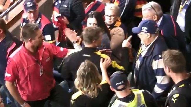 Damien Hardwick points his finger at an Adelaide fan during an altercation after the final siren on Thursday night.