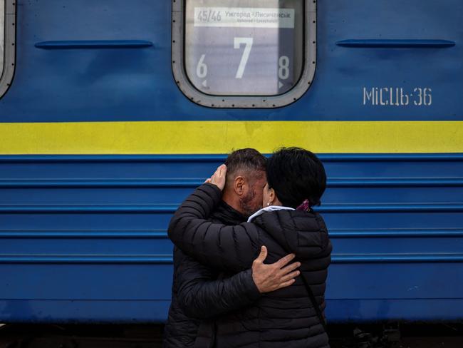 A man embraces his wife as she is about to board a train at Slovyansk central station, in the Donbas region of eastern Ukraine. Picture: Ronalda Schemidt/AFP