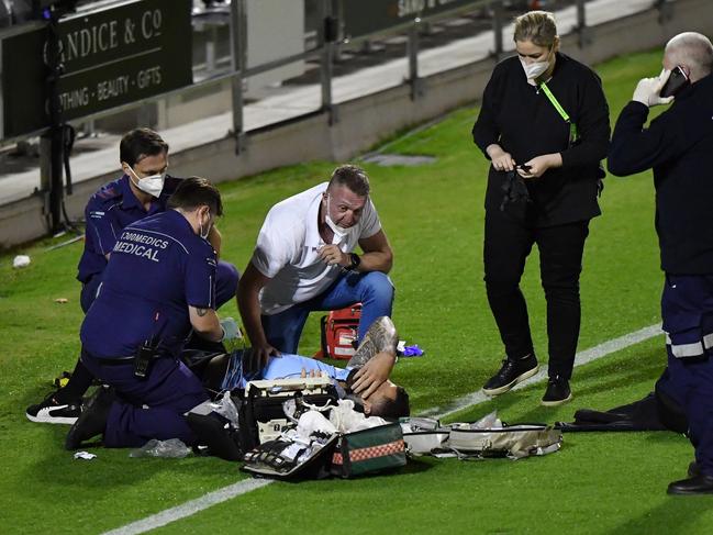 Andrew Fifita (on ground) of the Sharks is seen surrounded by medical staff on the field. AAP injury.