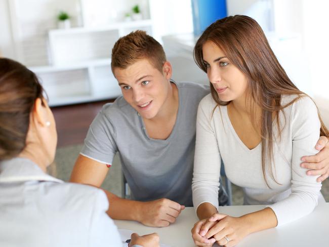 A couple discussing their home loan with a mortgage broker. Picture: iStock.