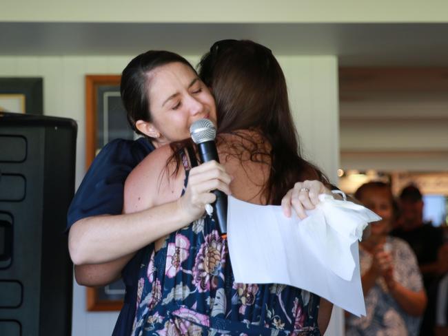 Kelly Hardy (right) embraces sister Jamienne Thompson at Ms Hardy’s “living funeral” on the Gold Coast.