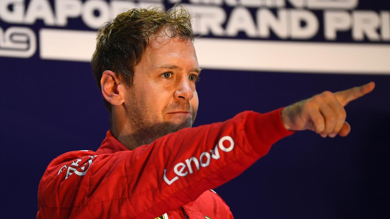 Race winner Sebastian Vettel celebrates on the podium in Singapore.
