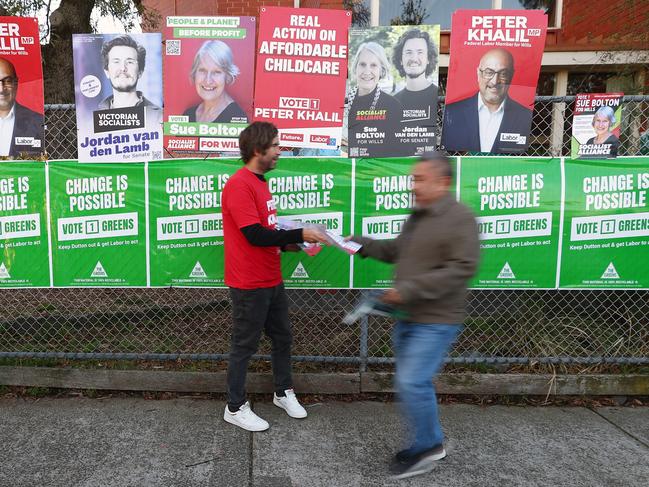 Party supporters hand out how to vote cards in the seat of Wills. Picture: Getty Images