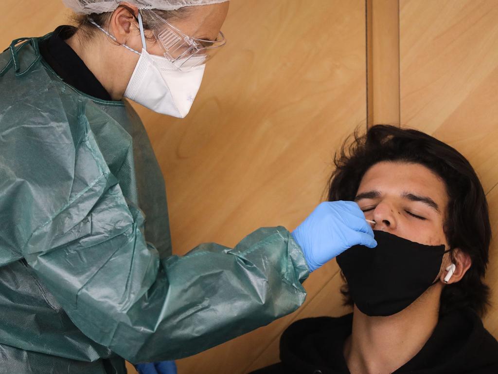 A health worker takes a nasal swab of a passenger at an airport in Nice, southern France. Picture: AFP