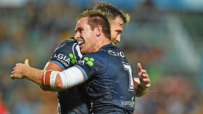 Michael Morgan celebrates his try with Cowboys teammate Gavin Cooper. Picture: Zak Simmonds