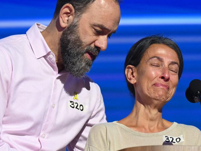 Jon Polin comforts his wife Rachel Goldberg as she speaks about their son Hersh Goldberg- Polin, at the Democratic National Convention. Picture: AFP