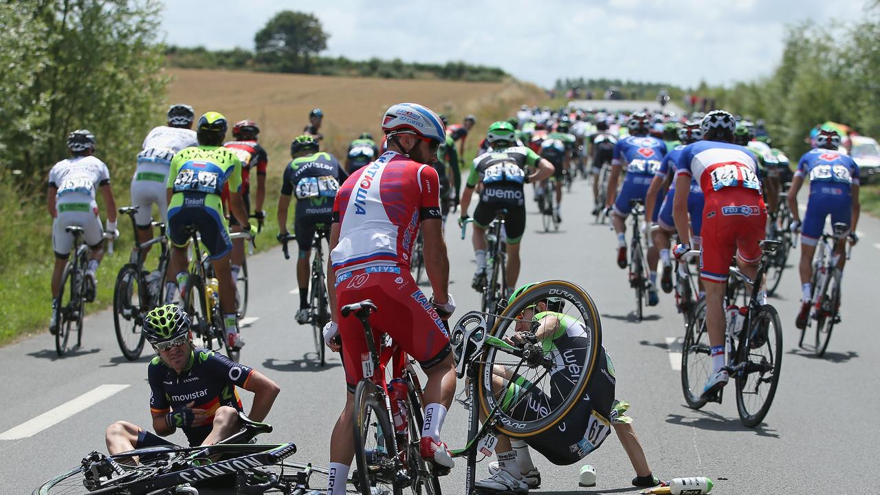 LE TOUQUET-PARIS-PLAGE, FRANCE - JULY 08: Jesus Herrada Lopez (L) of Spain and the Movistar Team and Bauke Mollema (R) of The Netherlands and the Belkin Pro Cycling Team pick themselves up off the road after being in a crash involving Chris Froome of Great Britain and Team Sky just after the start of stage four of the 2014 Le Tour de France from Le Touquet-Paris-Plage to Lille on July 8, 2014 in Le Touquet-Paris-Plage, France. (Photo by Doug Pensinger/Getty Images)