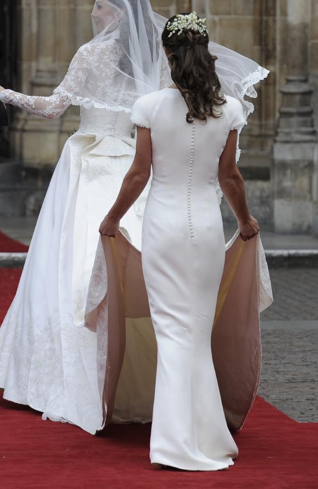 Kate Middleton arriving at Westminster Abbey for her wedding, followed by her sister Pippa.