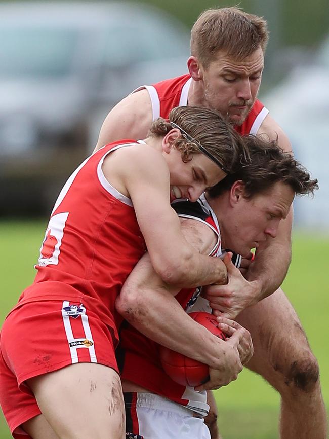 Alvie’s Micah Robb and Patrick Seal gang tackle Birregurra’s Mitch Russell.