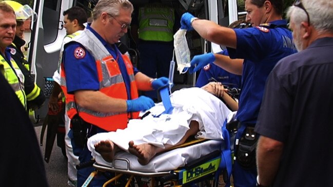 Ambulance officers treat Brodie Donegan after her car was hit by a drug driver on Christmas Day in 2009.