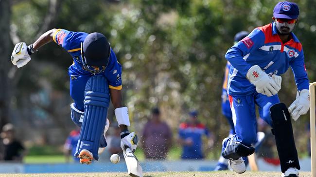 Grand United batter Hashan James makes his ground in front of Footscray United keeper Chathura Milan. Picture: Andy Brownbill