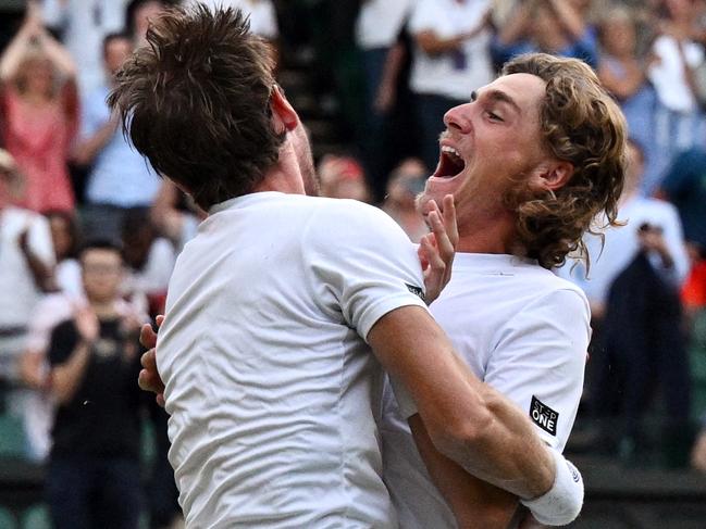 Australia's Matthew Ebden and Australia's Max Purcell (R) celebrate after winning against Croatia's Nikola Mektic and Croatia's Mate Pavic during their men's doubles final tennis match on the thirteenth day of the 2022 Wimbledon Championships at The All England Tennis Club in Wimbledon, southwest London, on July 9, 2022. (Photo by SEBASTIEN BOZON / AFP) / RESTRICTED TO EDITORIAL USE