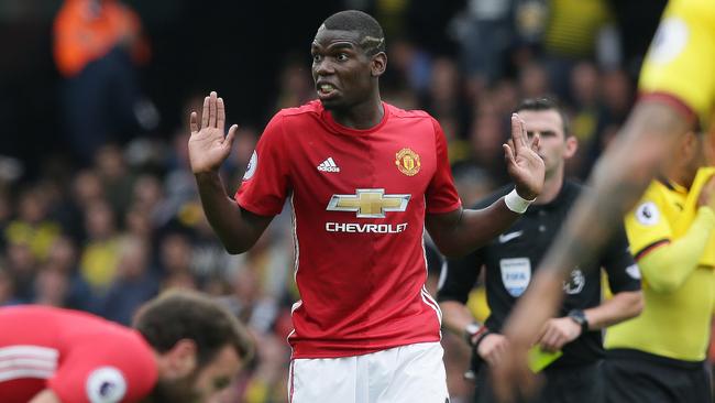 Manchester United's Paul Pogba holds up his hands and looks to the bench.