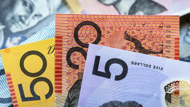 Australian money background.  Focus on foreground, blurred faces beneath. Notes generic